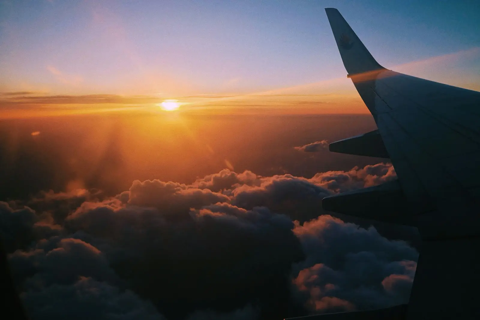 Airplane seats with sunset with outside window visible