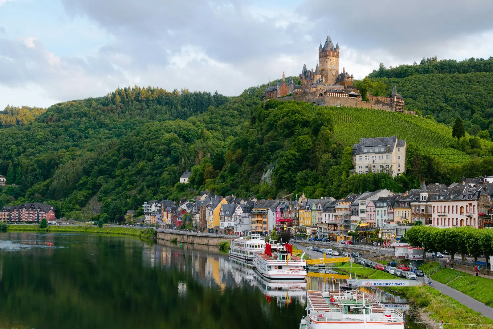 Scenic view of a German castle surrounded by forests and mountains during the weekend